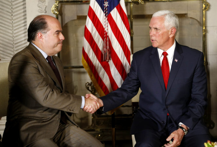 U.S. Vice President Mike Pence, right, shakes hands with Venezuelan opposition leader Julio Borges during a meeting at the residence of the US ambassador, in Lima, Peru, Friday, April 13, 2018. (AP Photo/Karel Navarro)